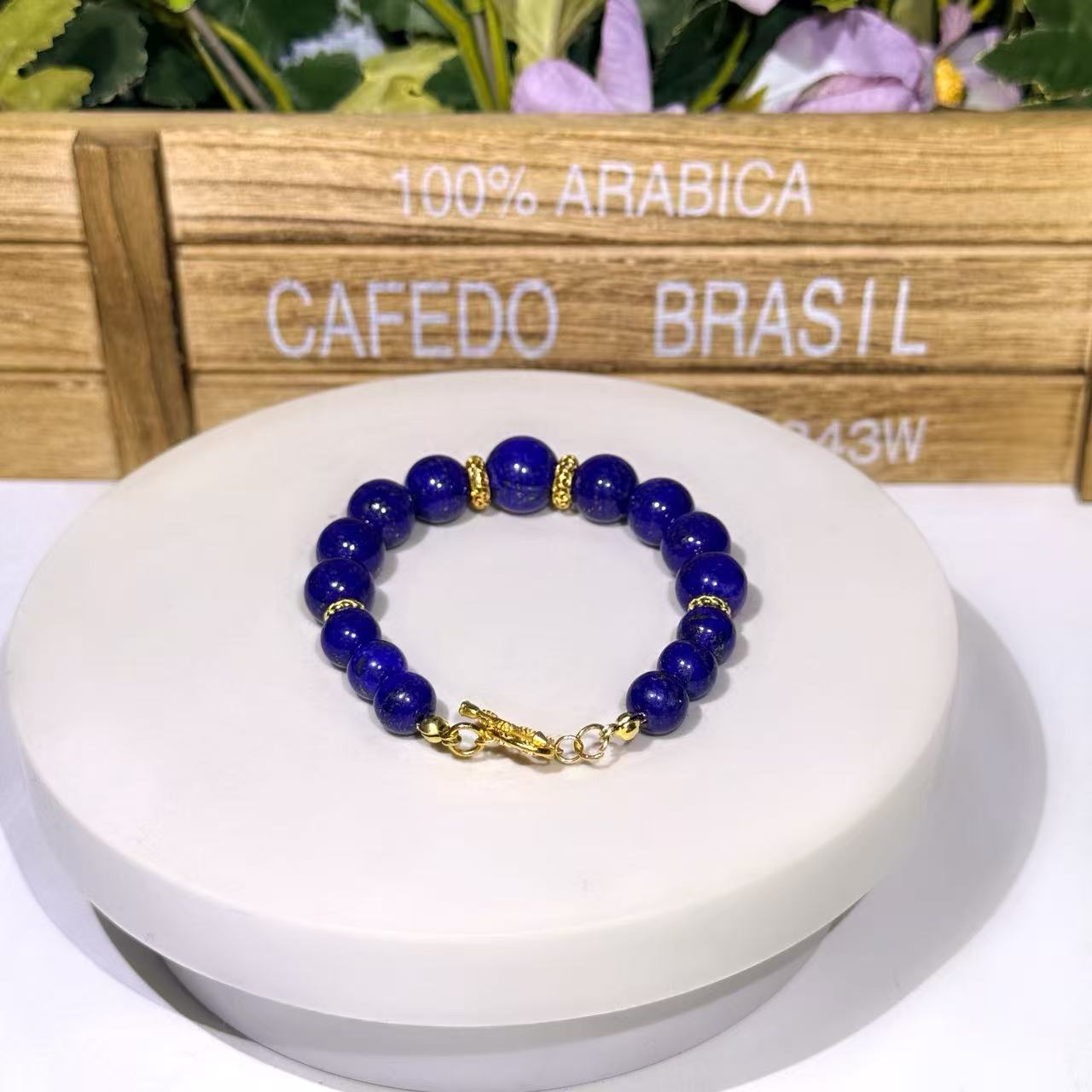 Sovereign Focal natural lapis lazuli bracelet showcasing a single deep indigo 12mm center bead framed tightly by textured gold spacer wheels on a uniform 10mm genuine gemstone band.