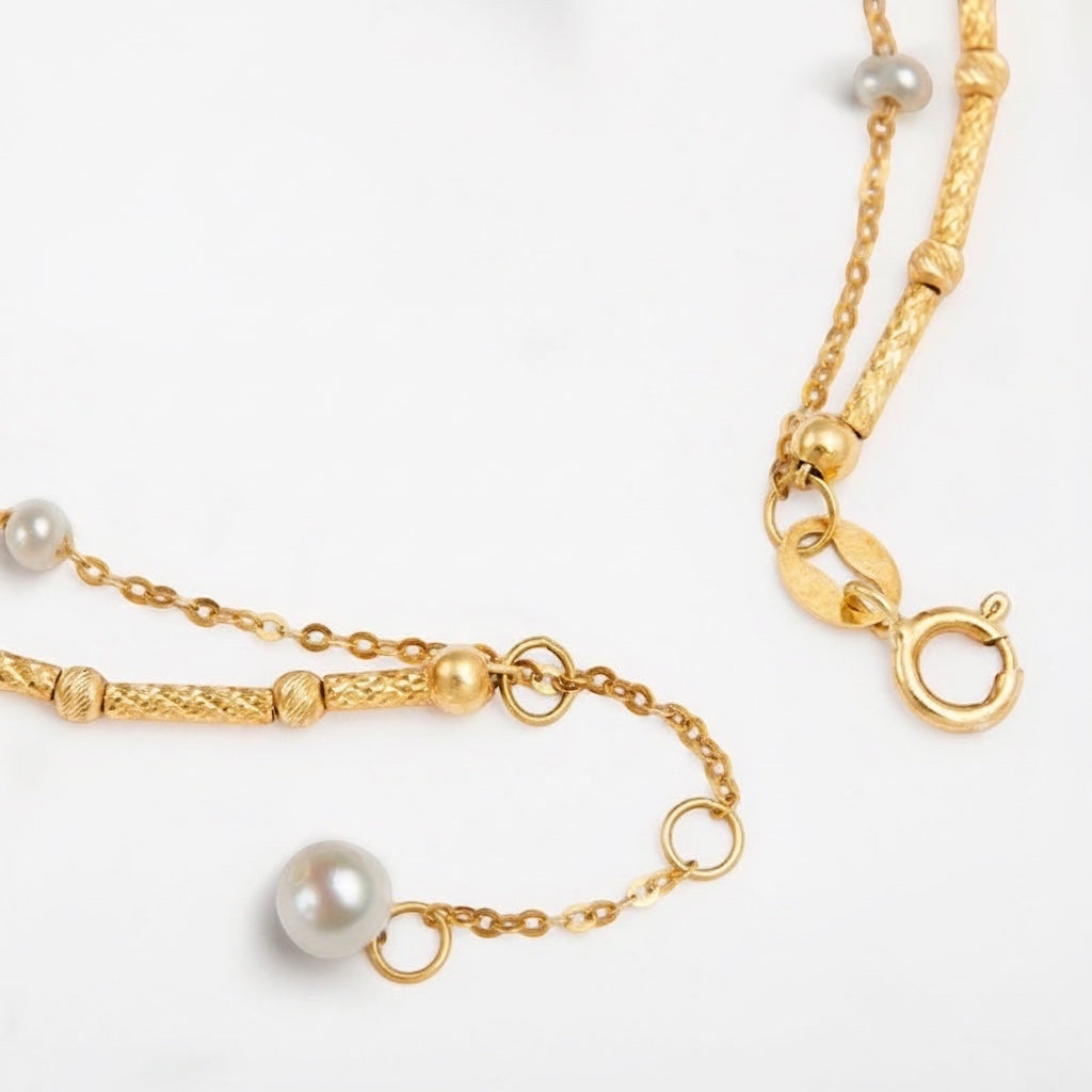 BoxUnboxed Artisanal Signature dual-layer bracelet with 18K gold textured bar chain and delicate pearl chain.