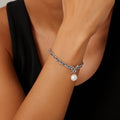 BoxUnboxed sterling silver anchor link bracelet with a single freshwater pearl charm and toggle clasp.